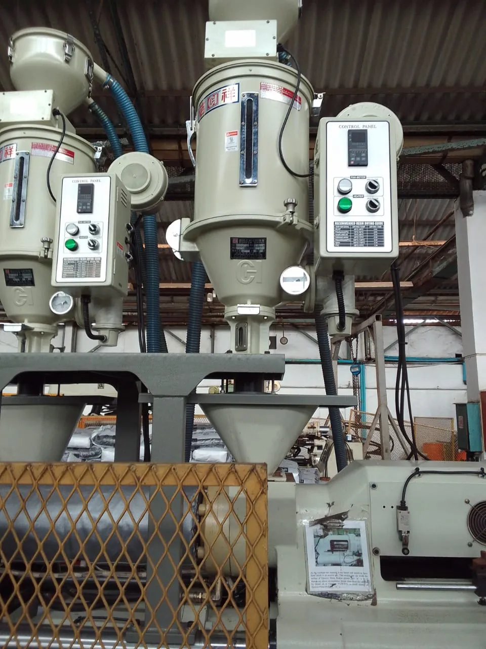 Resin hopper dryers on a plastics production line